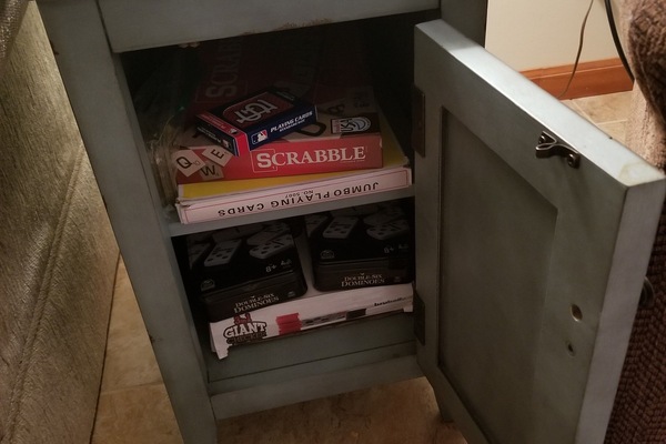 Games located inside end table next to sofa