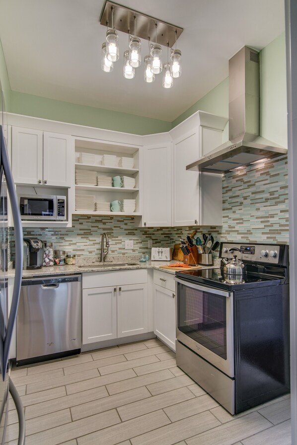 Enjoy cooking in this well-lit kitchen with a microwave, dishwasher, and oven.