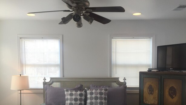 A bedroom with a bed, a ceiling fan, a television, and a nightstand. - Mayfaire, 3 miles to Wrightsville Beach. Very convenient  (Wilmington)