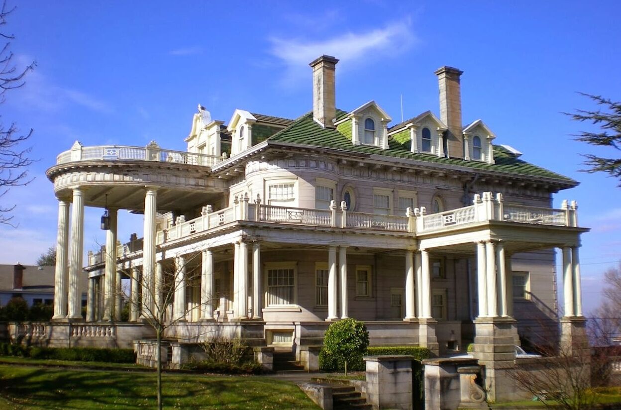 A large, historic building with a central rotunda, multiple balconies, and classical architecture.
