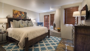 A bedroom with a large bed, a nightstand, a chair, a dresser, and a painting on the wall. - In The Heart Of Santa Fe, Walk to Everything Downtown, 3 Bed, 3 Bath Townhouse (Santa Fe)