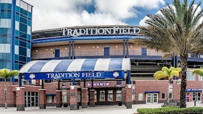 A stadium with a large sign reading "TRADITION FIELD" and a ticket booth.