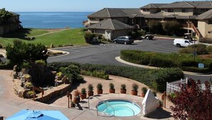 A residential area with a swimming pool, a small waterfall feature, and a view of the ocean. - Seascape Resort 2B Luxury Oceanview Villa, Steps From The Beach, 5 min to golf (Aptos)