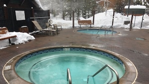 A pool area with a sign indicating 'SPA RULES' and a 'NO DIVING' sign.
