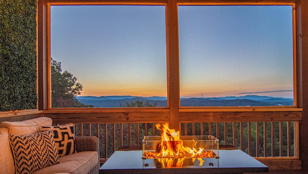 A wooden deck with a glass-top table and a fire feature, overlooking a mountainous landscape. - Mtn View Cabin 5 min to Downtown Blue Ridge w/Hot Tub and Firepit, Pet Friendly! (Blue Ridge)