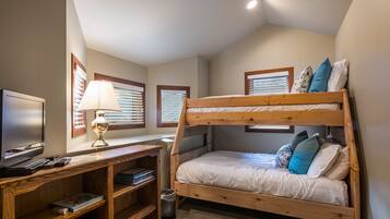 Cozy retreat with a bunk bed, desk, and flat-screen TV.