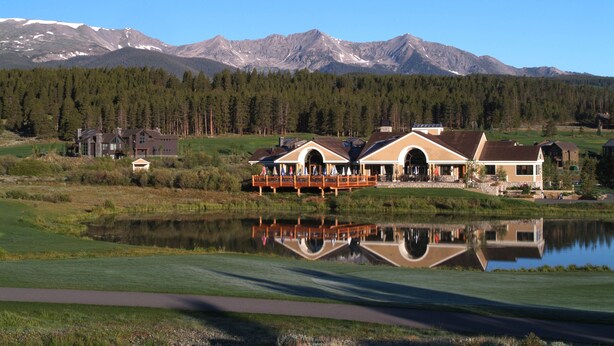 A lakeside lodge with a reflection in the water, surrounded by mountains and a forest. - Beautifully Renovated Condo, Steps From Main St & Gondola; Very Clean (Breckenridge)