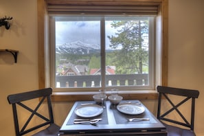 Enjoy meals with a view of the surrounding mountains and residential area from this dining area.