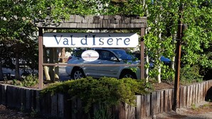A sign for Val d'Isere property management with a car parked in front. - Beautifully Renovated Condo, Steps From Main St & Gondola; Very Clean (Breckenridge)