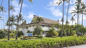 A two-story building with a tiled roof and a sign indicating it is a plantation house.