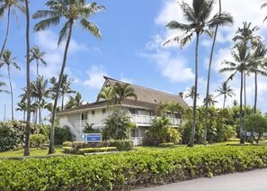 Stunning Plantation House with a traditional architectural style, surrounded by a lush garden and a balcony overlooking the grounds.