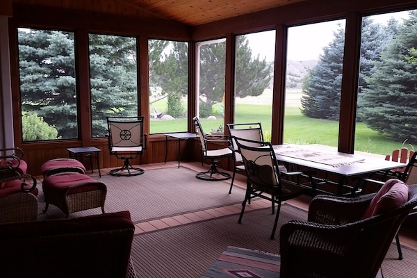 Comfortable patio furniture on screened in porch