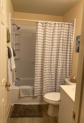 A bathroom with a shower, toilet, and sink. - Romantic  Condo,  Gated Pawley’s! Professionally cleaned every time! (Pawleys Island)