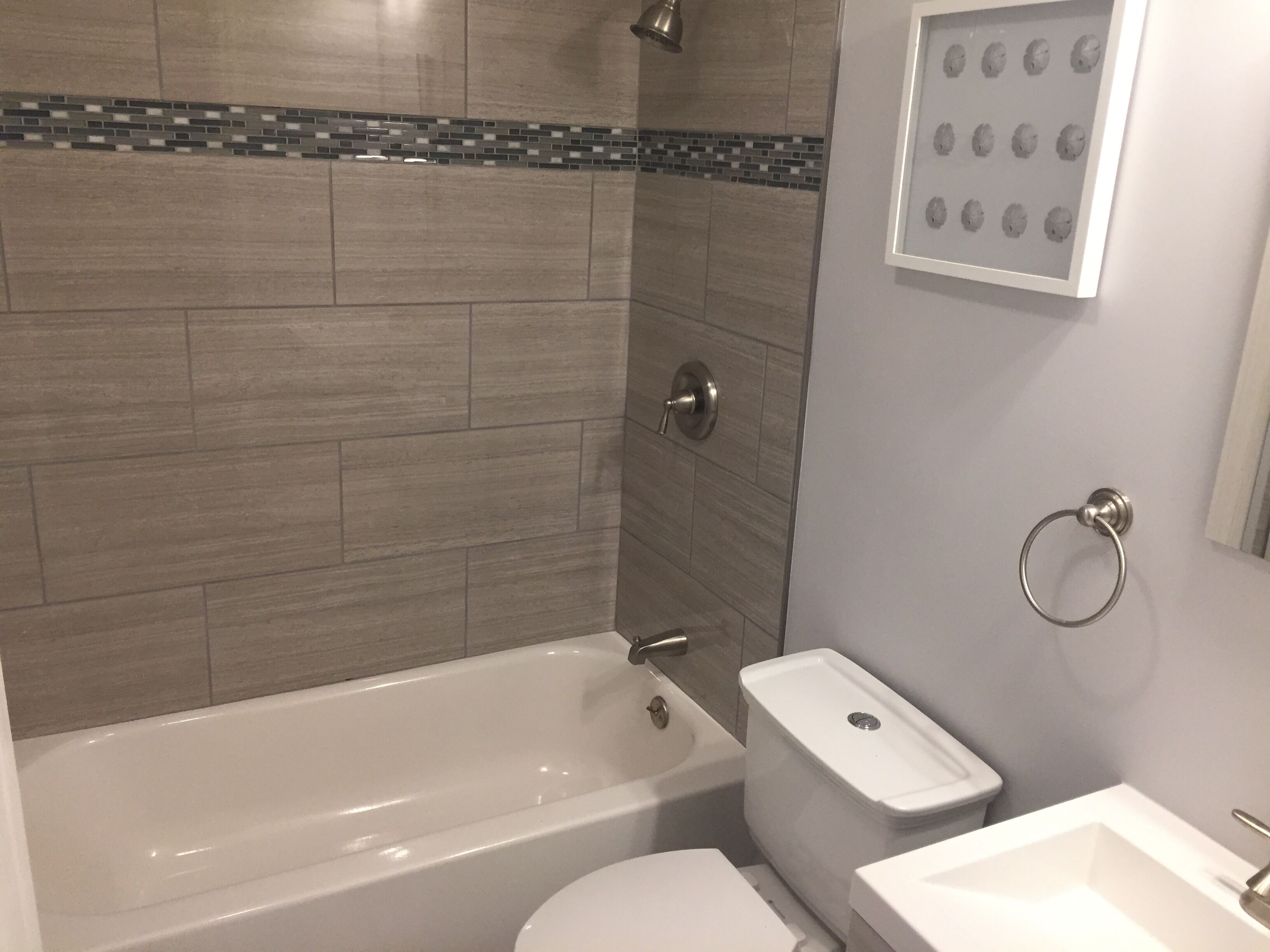 A bathroom with a bathtub, toilet, and sink.