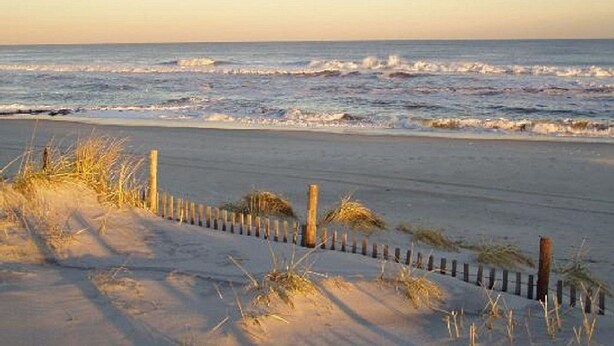 A beach with a wooden fence and sand dunes. - Great Location / Walk to Everything!  4BR Big Backyard (Beach Haven)