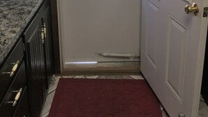 A door with a window, a red mat, and a sign above the door. - Main Floor 2 bedroom, 1 bath, Easy Walk to Mayo Clinic, trails, parks, shopping (Rochester)