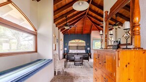 A bedroom with a large bed, wooden ceiling beams, a bench, and a dresser. - AMAZING OCEAN VIEWS! "House in the Sky" Monte Paraiso (Playa Hermosa)