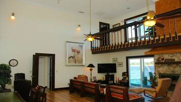 Relax in this spacious living area with a fireplace, ocean views, and a flat-screen TV.