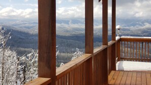 A wooden balcony with a view of snow-covered mountains. - Breathtaking views from decks! Private acres next door to Dollywood! Beautiful! (Pigeon Forge)