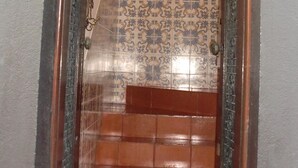 A doorway with a number sign, a tiled wall, and a framed picture. - Mira Porto House Cellars (Porto)