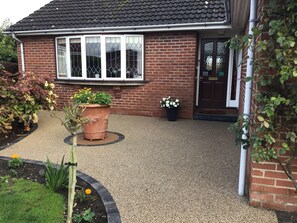 A residential house with a brick exterior, a tiled roof, and a gravel driveway. - Beautiful selfcontained annexe situated on the edge of the historical city York (Dunnington)