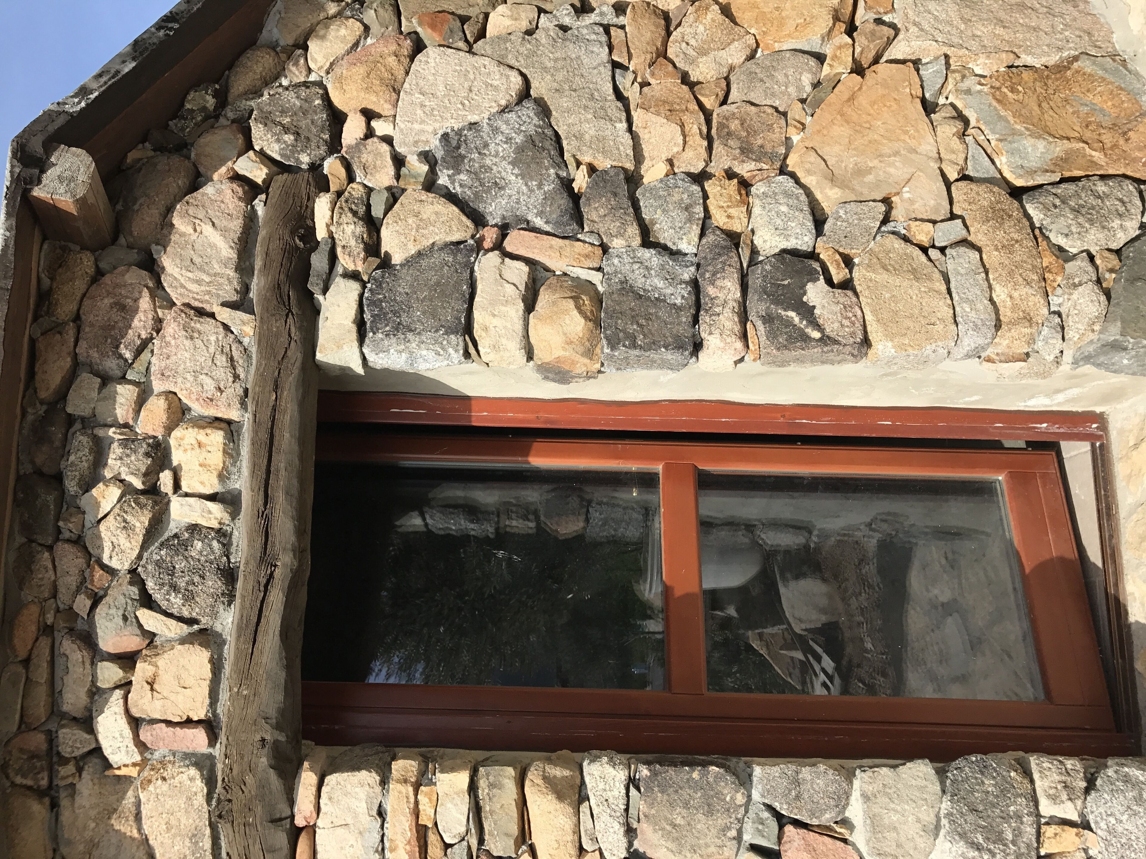 A stone wall with a window.