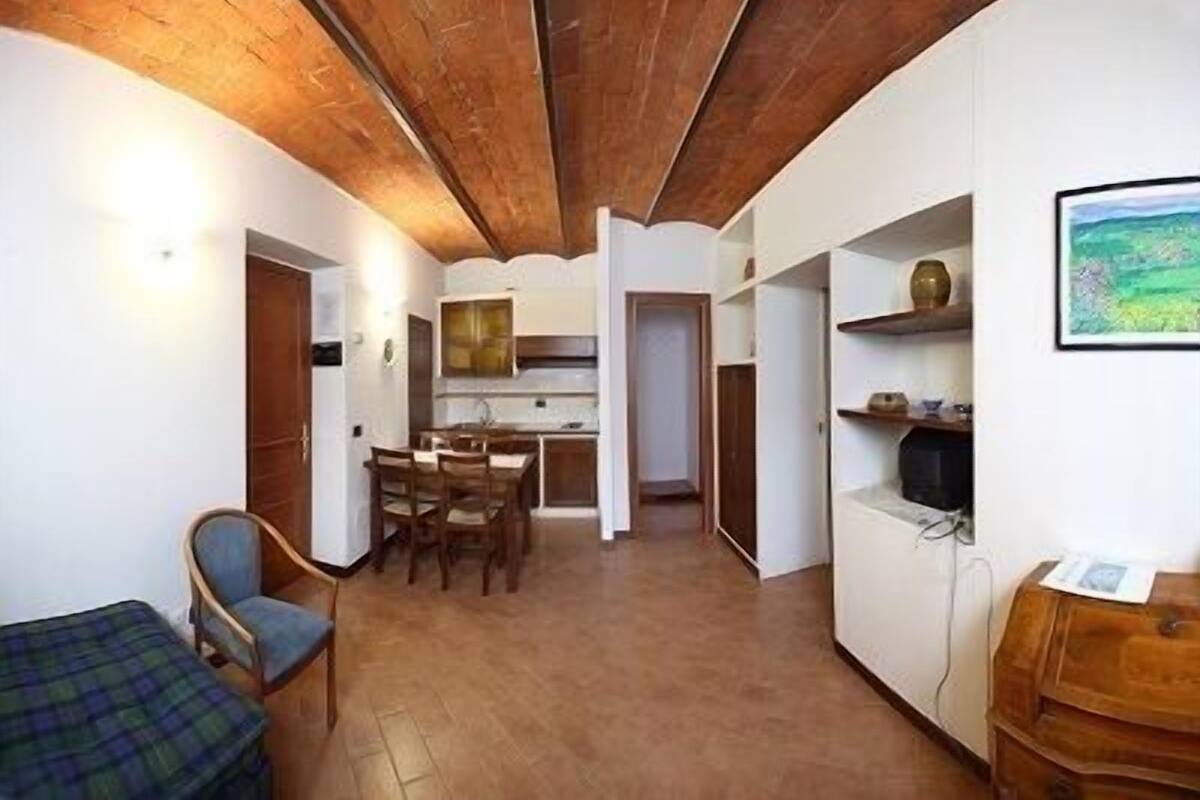 A compact living space with a kitchen, dining area, and a small seating area.