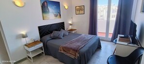 1 dormitorio, caja fuerte, escritorio y tabla de planchar con plancha
