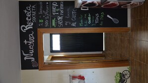 A kitchen with a chalkboard menu listing items like 'Sabor y Paciencia' and 'Al Gusto'. - Disconnect from the routine and enjoy the countryside (Berja)