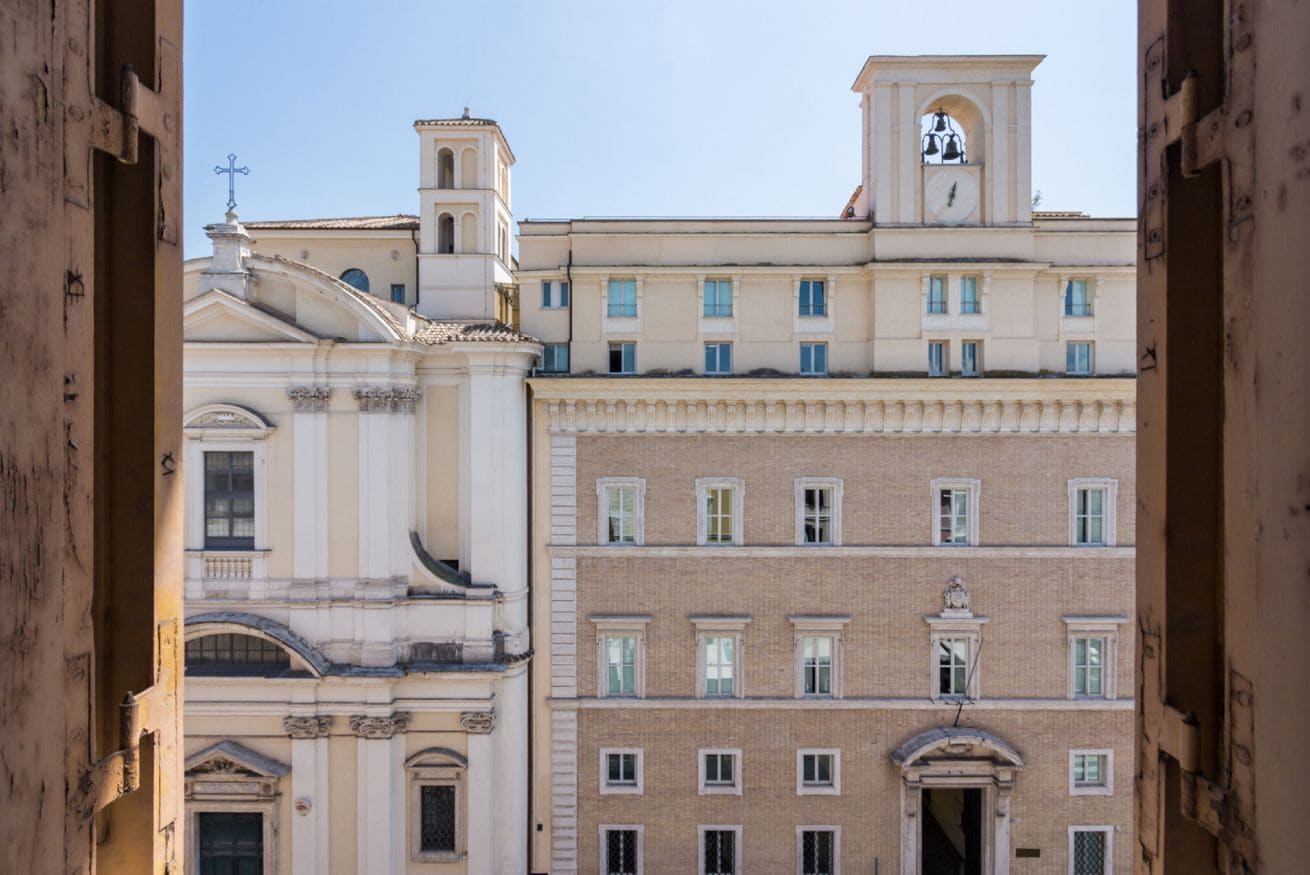 A multi-story building with classical architecture, featuring a clock tower and arched windows.