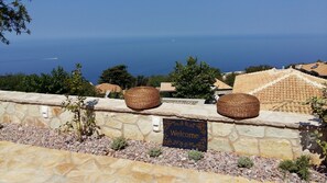 Guests can step into a warm welcome with a mat and woven baskets atop a stone wall.