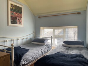 A bedroom with two single beds, a wooden dresser, a window with blinds, and a poster on the wall. - Charming Kinvara Cottage, Walk to bay,Parking,Cliffs of Moher &Wild Atlantic Way (Kinvara)
