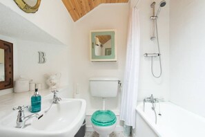 A bathroom with a white sink, a toilet, and a bathtub. - Charming Kinvara Cottage, Walk to bay,Parking,Cliffs of Moher &Wild Atlantic Way (Kinvara)
