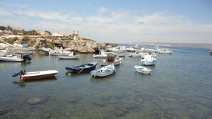 A marina with various boats docked, clear water, and a rocky shoreline with buildings in the background. - Registered Holiday home in sunny Rojales on the Costa Blanca (Ciudad Quesada)