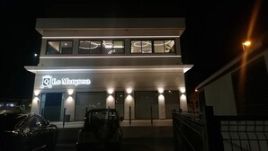 A two-story building with a modern design, featuring a large illuminated sign reading "La Marquesa." - Registered Holiday home in sunny Rojales on the Costa Blanca (Ciudad Quesada)