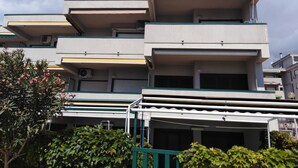A multi-story building with balconies and a gated entrance. - A WINDOW ON THE SEA (Roccalumera (ME))