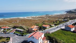 A coastal town with houses, a road, and a beach. - Barrañan beach apartments, Apartment 22 (Arteixo)
