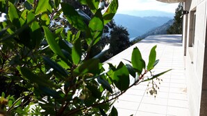 A pathway leading to a building with a view of mountains in the distance.