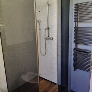 A shower with a glass door, a wooden floor, and a tiled wall. - Wonderful Country House near Venice (Dolo)