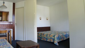 Une pièce comprenant un lit, un bureau et une chaise.