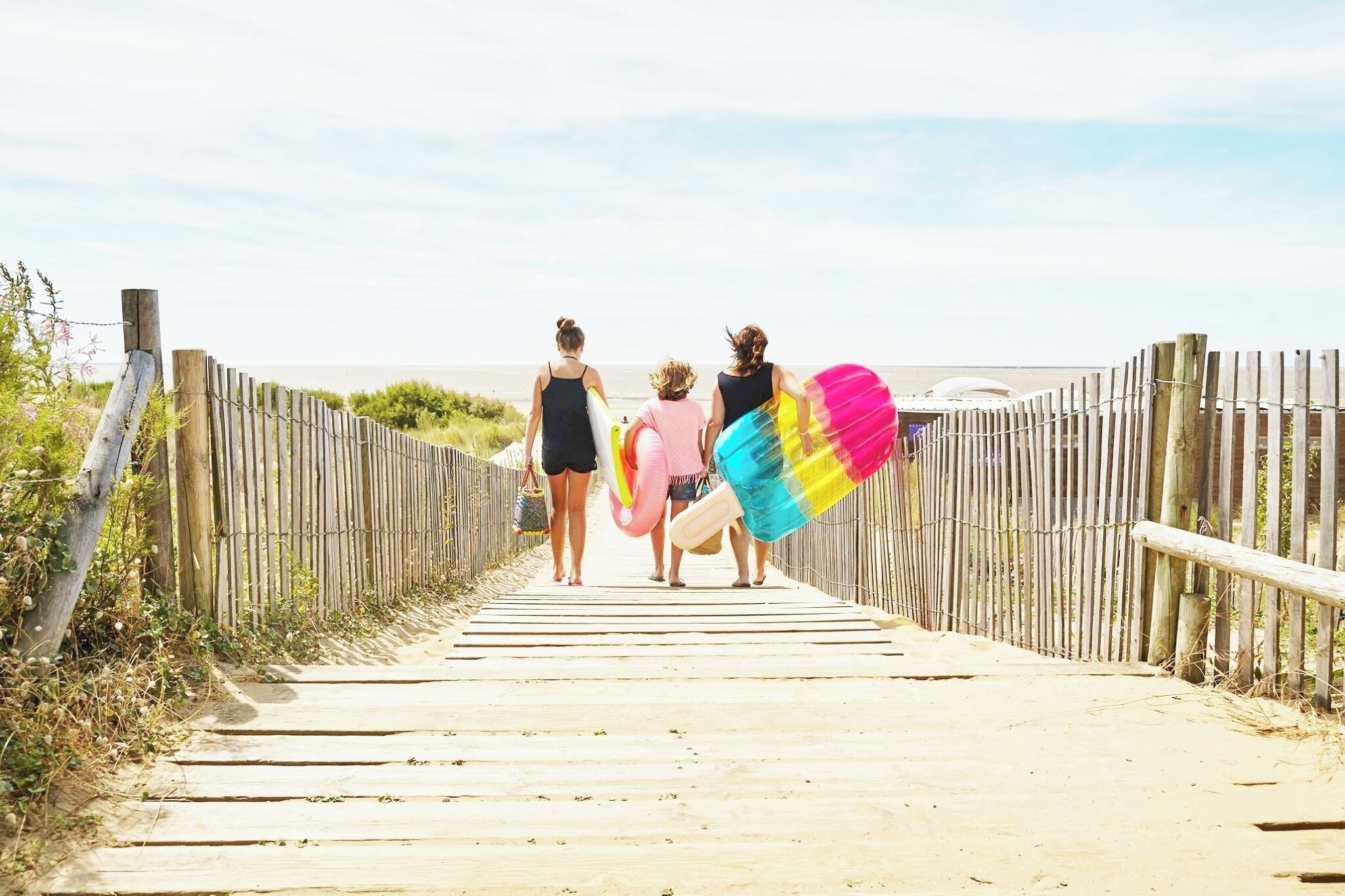 A wooden pathway leading to a beach.