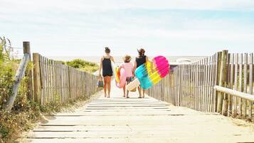 A wooden pathway leading to a beach.