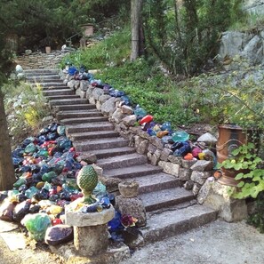 A stone staircase with colorful glass pebbles lining the steps.
