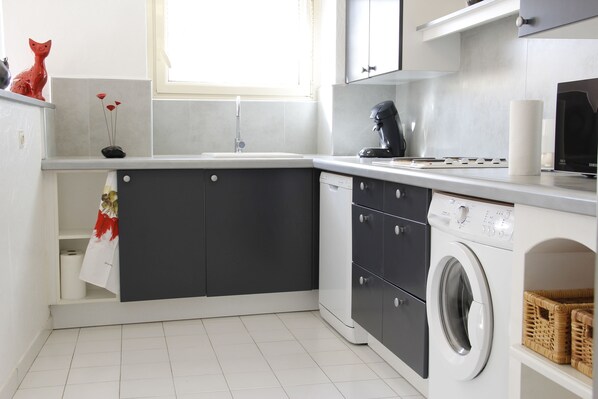 Enjoy cooking in this well-equipped kitchen with dishwasher, washer, and dryer.