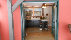 A kitchen with a sign reading "LAKE LIFE", wooden cabinets, a bar stool, and a ceiling fan. - WELCOME  TO THE COUNTRY - LAKE FRONT PROPERTY - THE FOX DEN STUDIO (Red Hook)