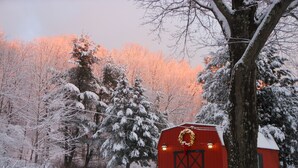 A red barn with a wreath on the door, surrounded by snow-covered trees and a snowy landscape. - WELCOME  TO THE COUNTRY - LAKE FRONT PROPERTY - THE FOX DEN STUDIO (Red Hook)