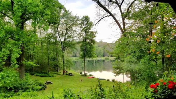 A serene lakeside garden with a picnic area, a small pond, and lush greenery. - WELCOME  TO THE COUNTRY - LAKE FRONT PROPERTY - THE FOX DEN STUDIO (Red Hook)