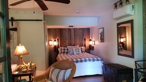 A bedroom with a bed, a chair, a lamp, a ceiling fan, and a mirror. - WELCOME  TO THE COUNTRY - LAKE FRONT PROPERTY - THE FOX DEN STUDIO (Red Hook)
