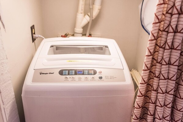 A Magic Chef appliance in a bathroom with a patterned shower curtain. - Modern 1850s Luray Farmhouse, Near Shenandoah National Park, Lake Arrowhead (Luray)