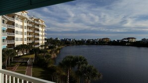 A waterfront hotel with multiple balconies, a landscaped garden, and a view of the water. - On 30A Water lovers dream!! 4 gorgeous pools, Lake and Ocean . Pet Friendly (Panama City Beach)